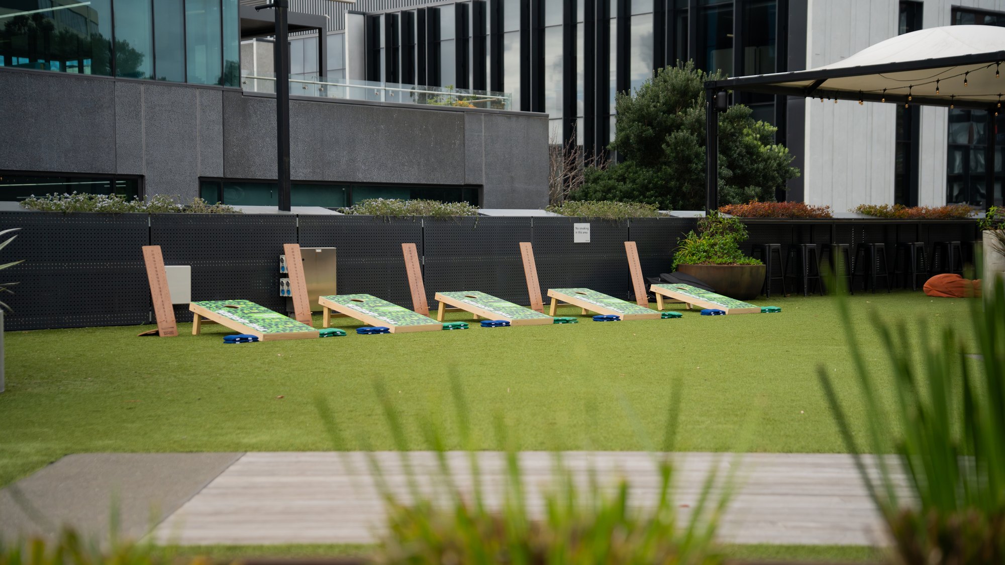 The-Green_Cornhole-League_Gallery-Wide Teams playing cornhole on the lawn at The Green