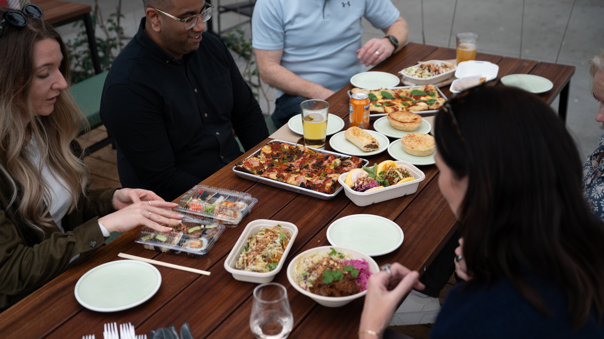 The-Green_Why-Come_Variety-and-Choice A shared table spread with dishes from several of The Green eateries